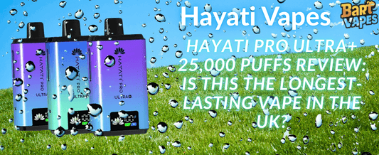 Three Hayati Pro Ultra+ vape devices are displayed on a grassy field with a blue sky background. Water droplets overlay the image. Text highlights a review of the 25,000-puff vape's longevity.